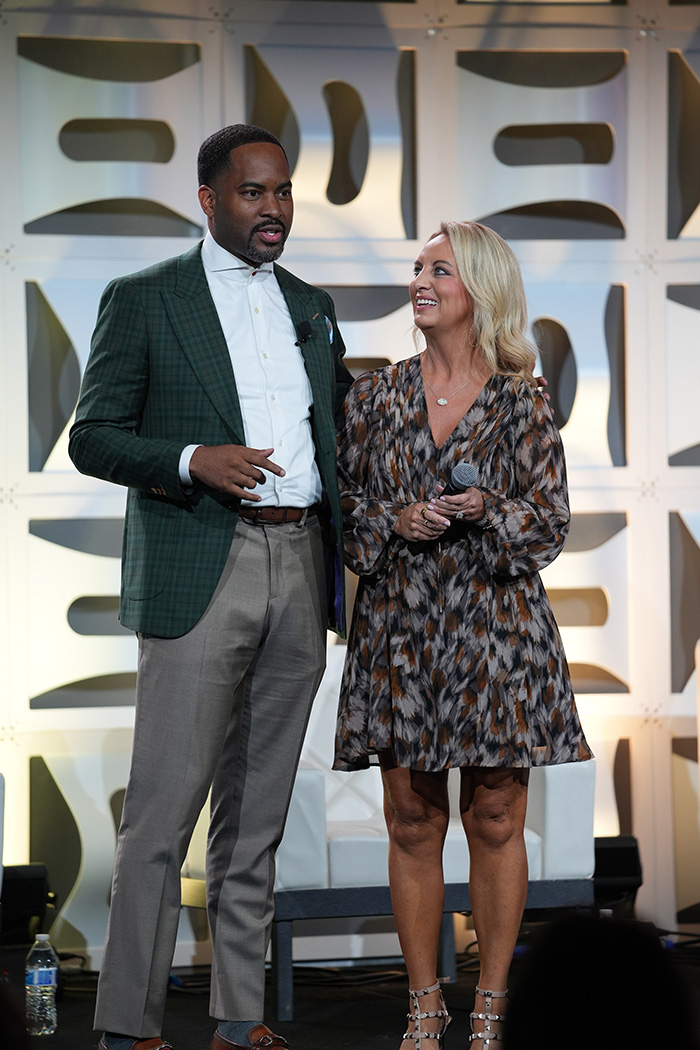 Fred Yeakey and Carlie Oakley speak on stage about the partnership at an annual conference for the Eight Eleven Family of Companies.